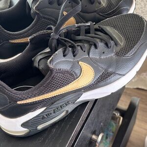 Nike Black Sneakers with Gold Swoosh Accent